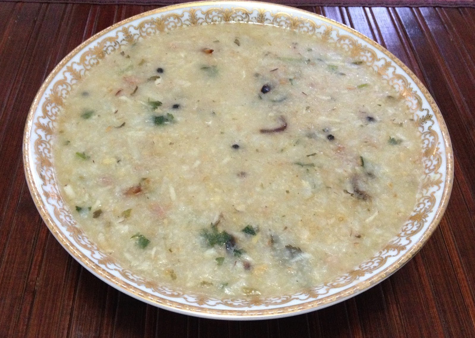 Nutritious bowl of rice gruel with fresh ingredients, a healthy and traditional meal.