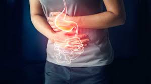 A happy person holding their stomach, symbolizing improved digestion and gut health.